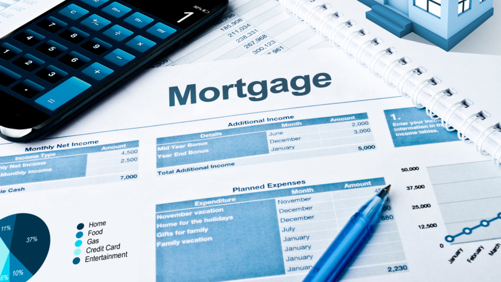 A mortgage application is one a table with a calculator and pen for the blog asking "What Types of Mortgages Are Assumable?"