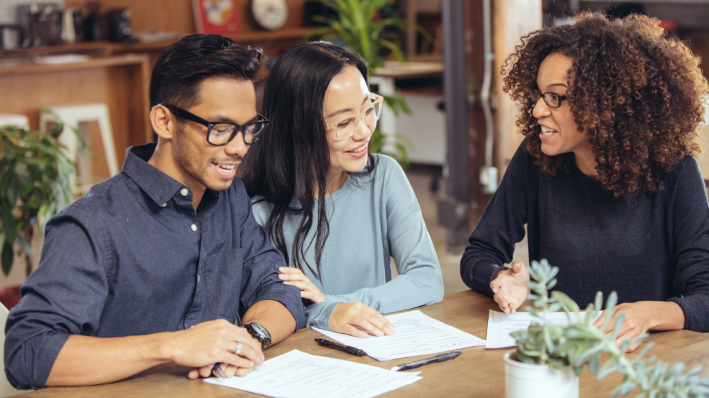 A couple is meeting with an advisor about their FHA assumable mortgage.