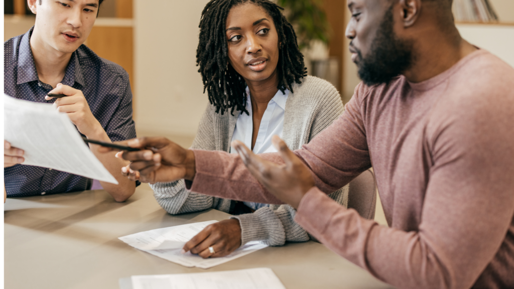 Homebuyers are meeting to discuss getting an FHA assumable mortgage loan. 