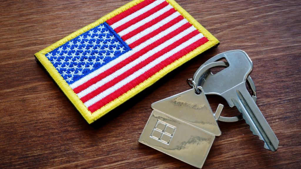 An American flag patch sits next to a house key with a house keychain for new homeowners.